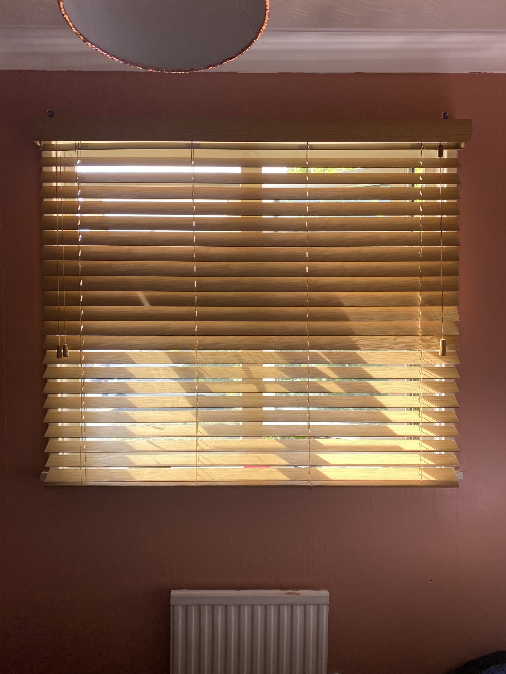 White faux wood Venetian blinds with grey fabric tapes fitted in an Essex living room