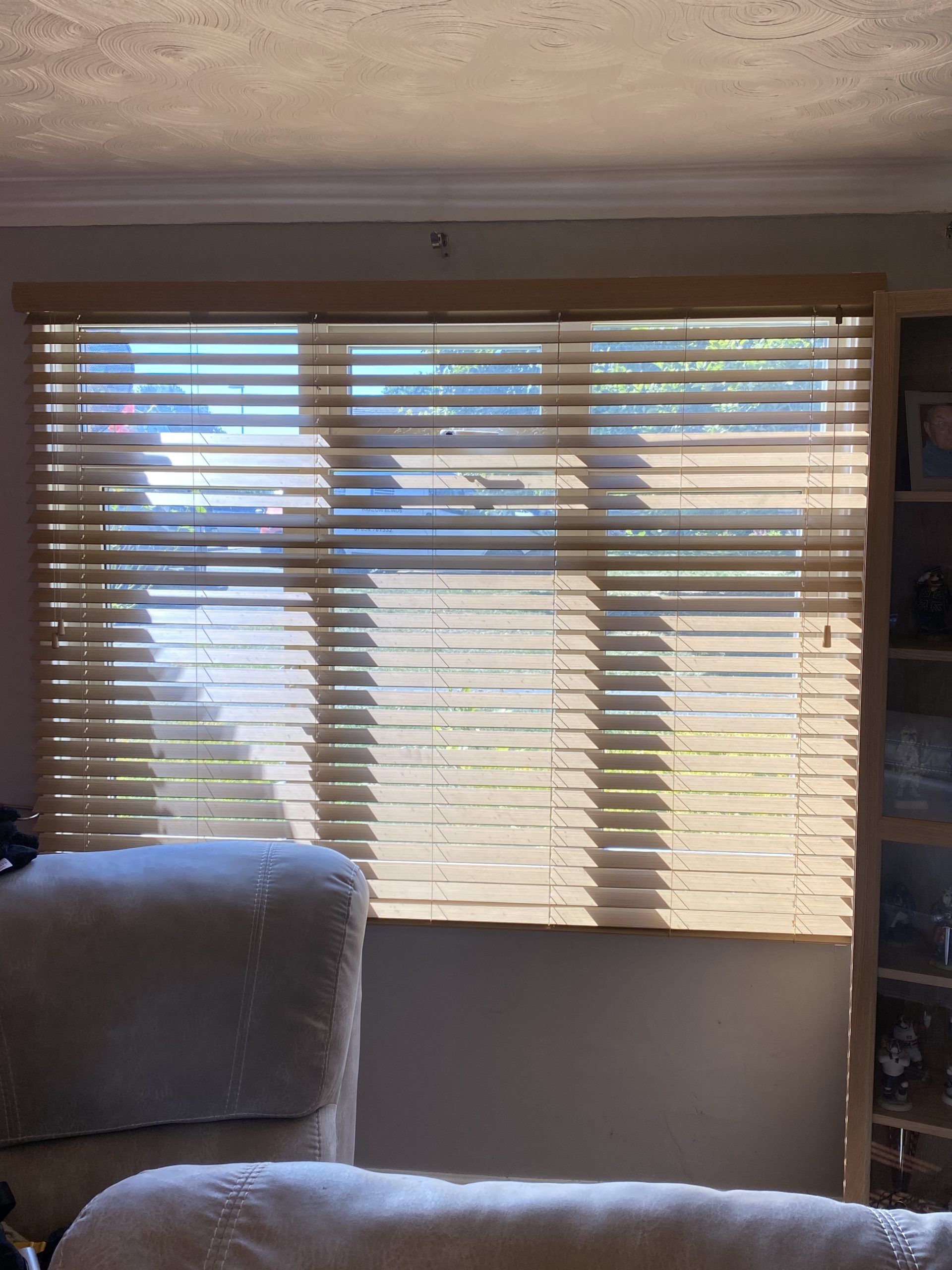 Faux wood blind slats showing sophisticated wood grain finish