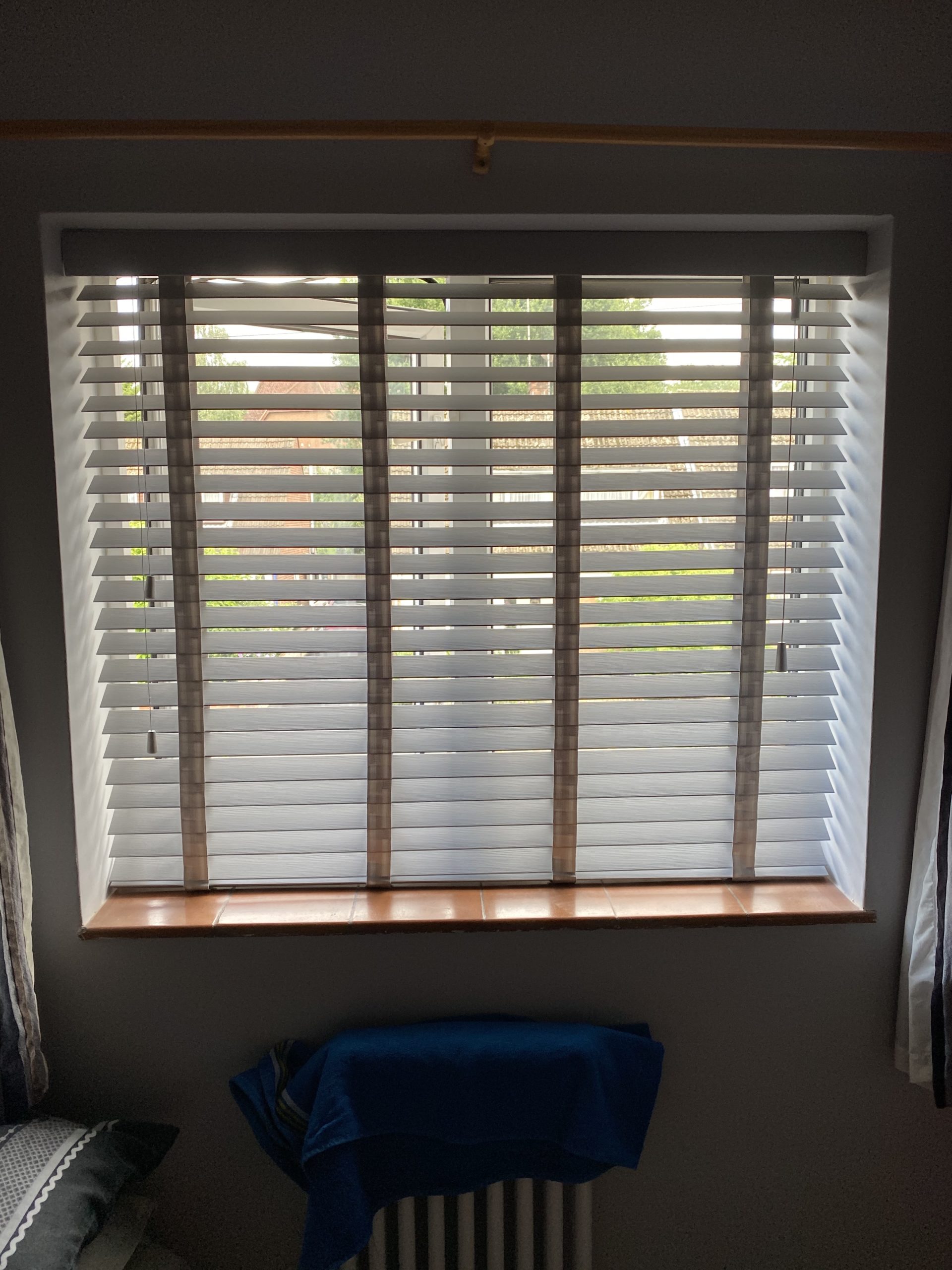 Custom fitted faux wood blinds in a bright Essex home conservatory